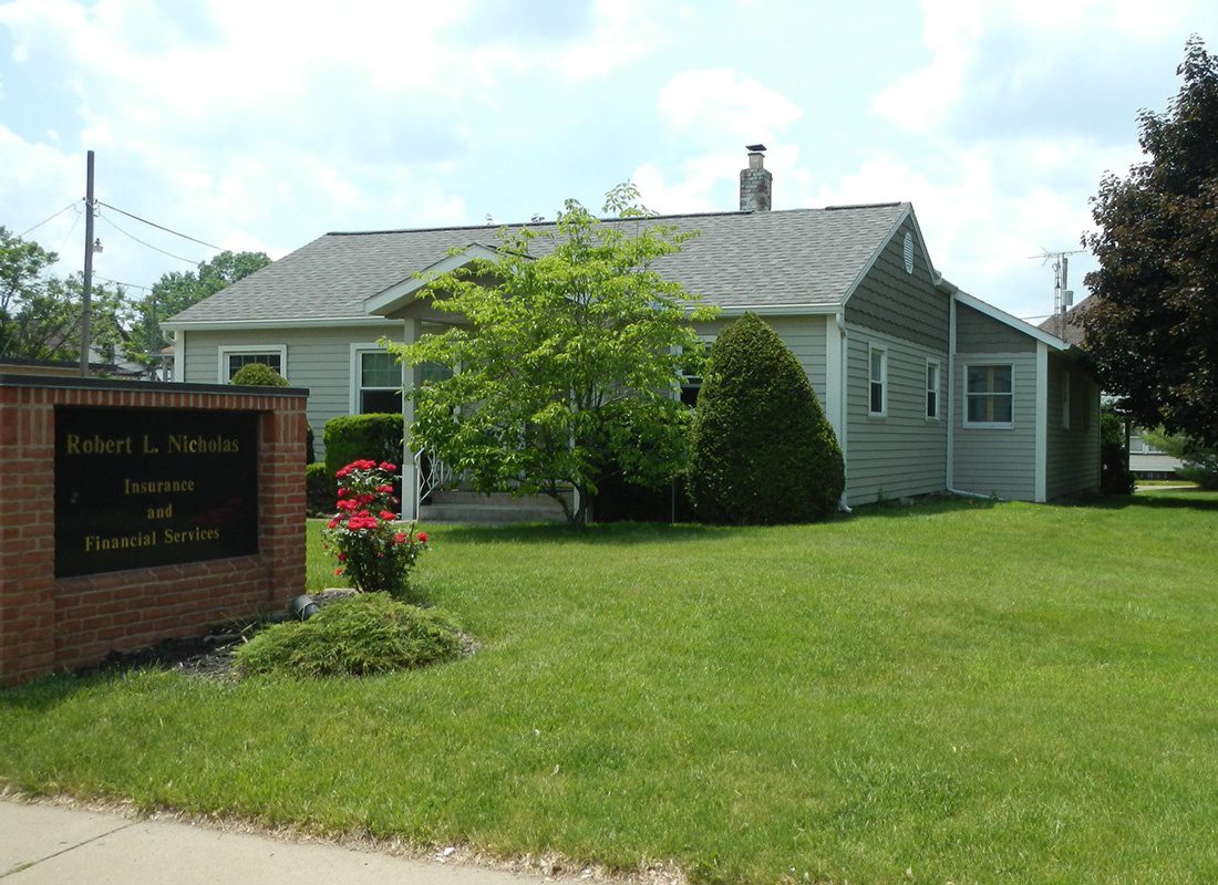 About Our Agency - Exterior View of Robert L. Nicholas Office and Front Sign on Green Grass with Pretty Landscaping in Canton Ohio